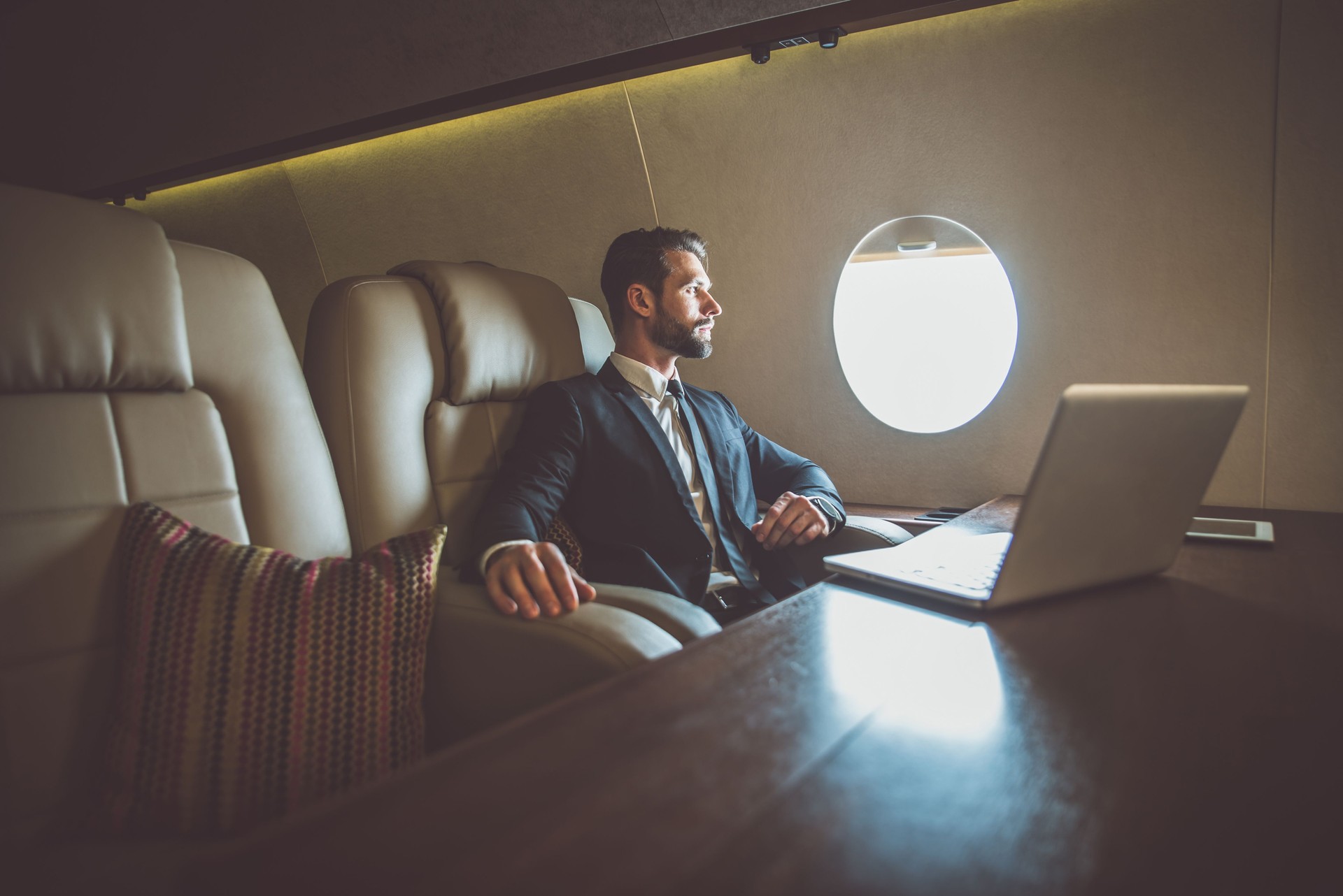 Businessman Looking Away While Sitting In Corporate Jet